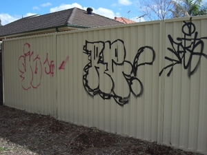 Fence with graffiti before cleaning